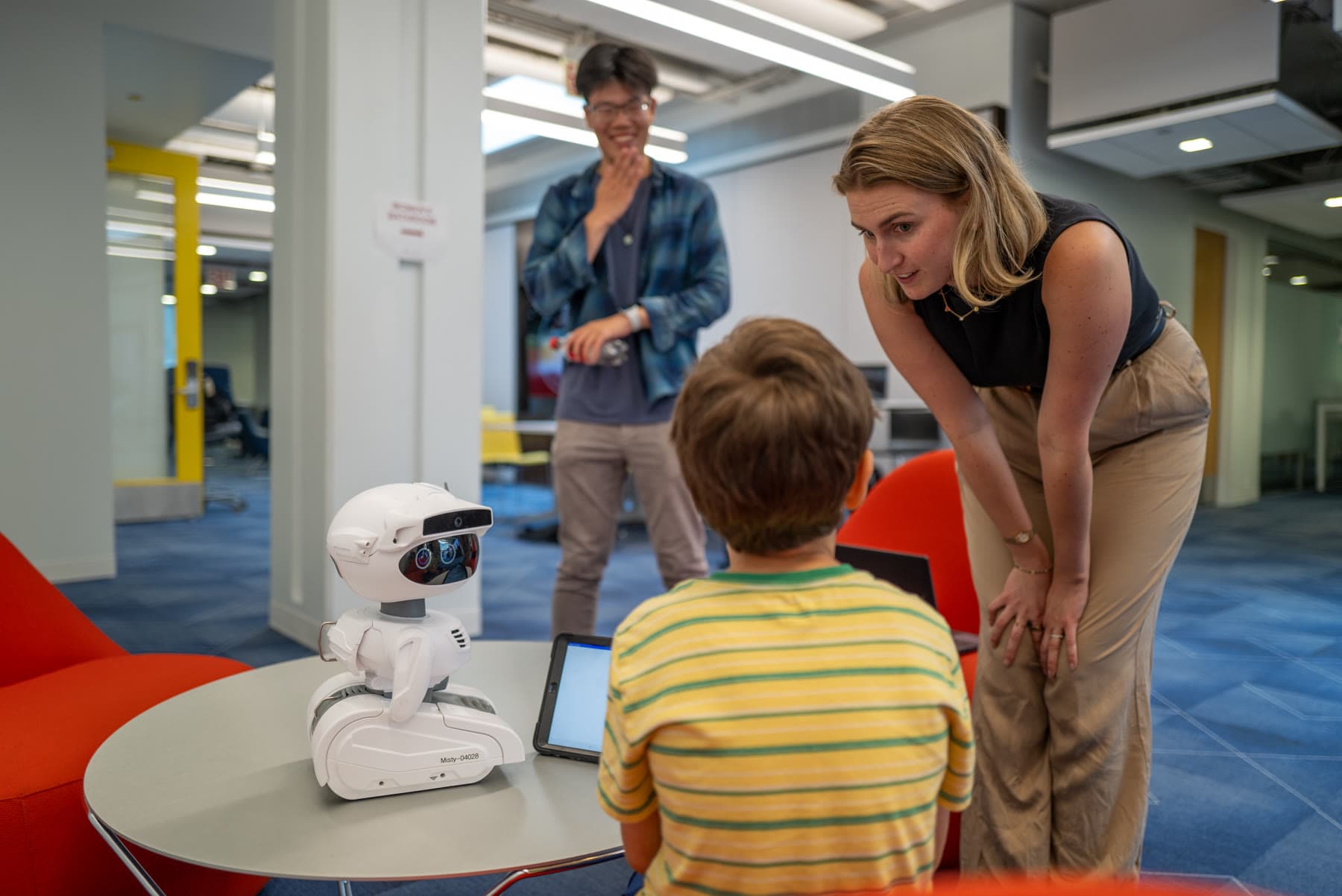 Tess observing a child interact with a Misty robot during a study